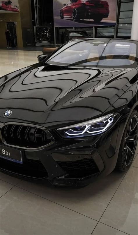 A Black Bmw Car Is Parked In A Showroom