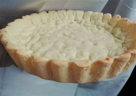 An Uncooked Pie Sitting On Top Of A White Tablecloth Covered Table Cloth