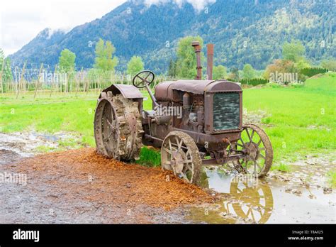 Vintage tractor farm equipment on a real farm, rusted and broken down ...