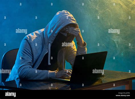 Hooded Computer Hacker Stealing Information With Laptop Stock Photo Alamy