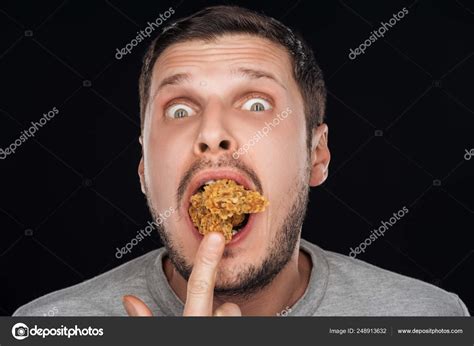 Man Putting Mouth Chicken Nuggets While Looking Camera Isolated Black