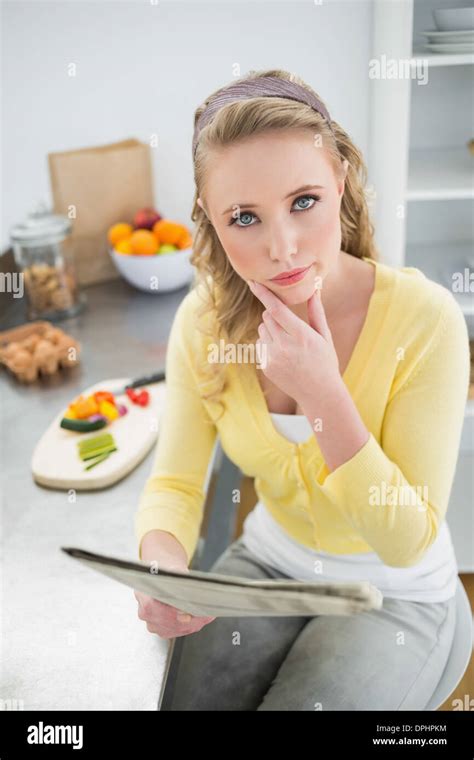 Pensive Cute Blonde Holding Newspaper Stock Photo Alamy