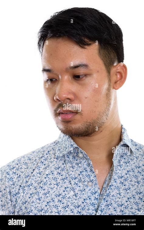 Face Of Young Asian Man Thinking While Looking Down Stock Photo Alamy