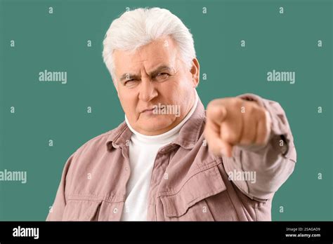 Mature Man Pointing At Viewer On Green Background Closeup Accusation Concept Stock Photo Alamy