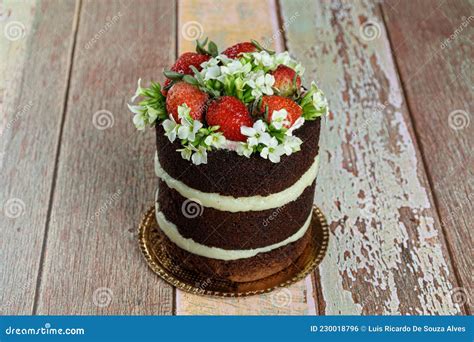 Naked Chocolate Cake Filled With Coconut Brigadeiro Decorated With Strawberries And White