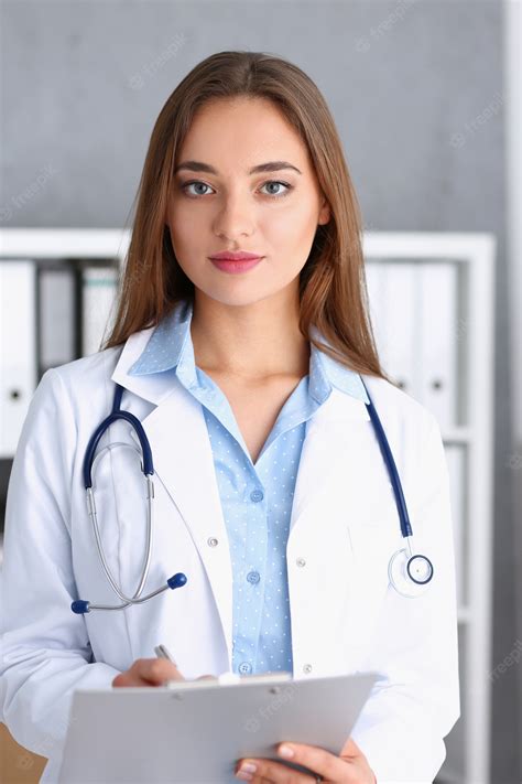 Premium Photo Beautiful Smiling Female Doctor Stand In Office