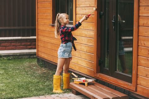 Premium Photo Little Beautiful Girl Painting The House