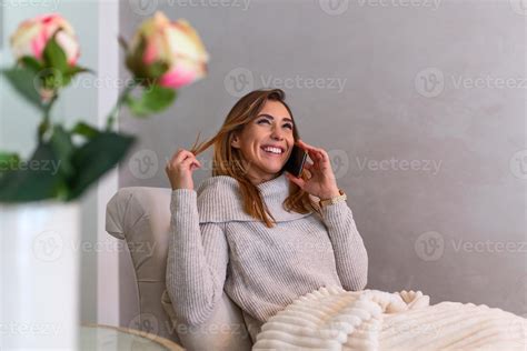 Happy Young Woman Caller Talking On Her Mobile Phone At Home Cheerful