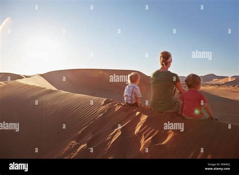 Mother And Sons Sitting On Sand Dune Namib Naukluft National Park Namib Desert Sossusvlei