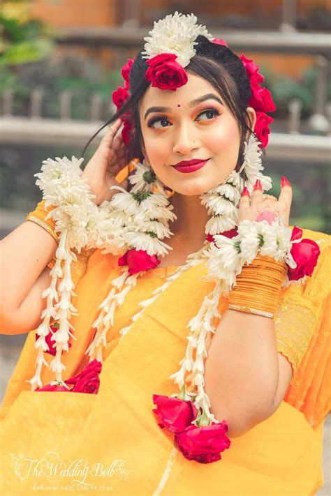 A Woman With Flowers In Her Hair Posing For The Camera While Wearing An