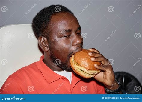 Minimal Side View Black Man Eating Burger Indoors Stock Image Image