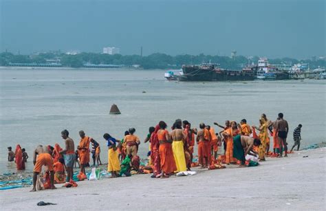 Premium Photo Pilgrim People Are Taking Bath At The Riverbank Of The