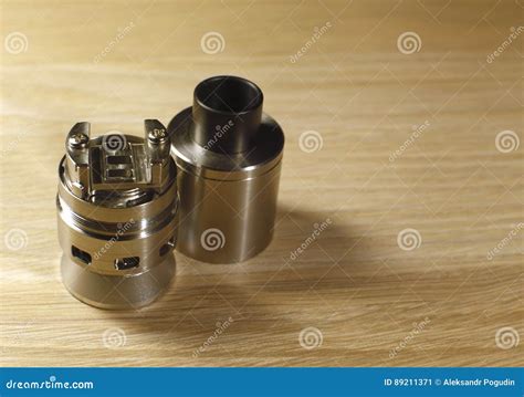 Vaping Rebuildable Dripping Atomizer Rda On Wooden Surface With Copy