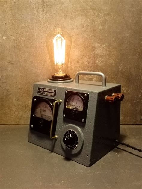 An Old Fashioned Radio Sitting On Top Of A Table Next To A Lightbulb