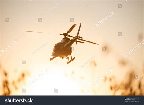 Passenger Helicopter Flying In Sunset Sky Stock Photo 335735999 ...