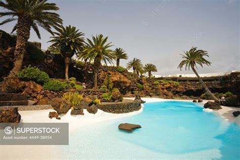 Swimming Pool With Palm Trees Near A Volcanic Cave Jameos Del Agua