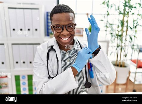 Young African Man Working As Doctor Using Gloves At Medical Clinic