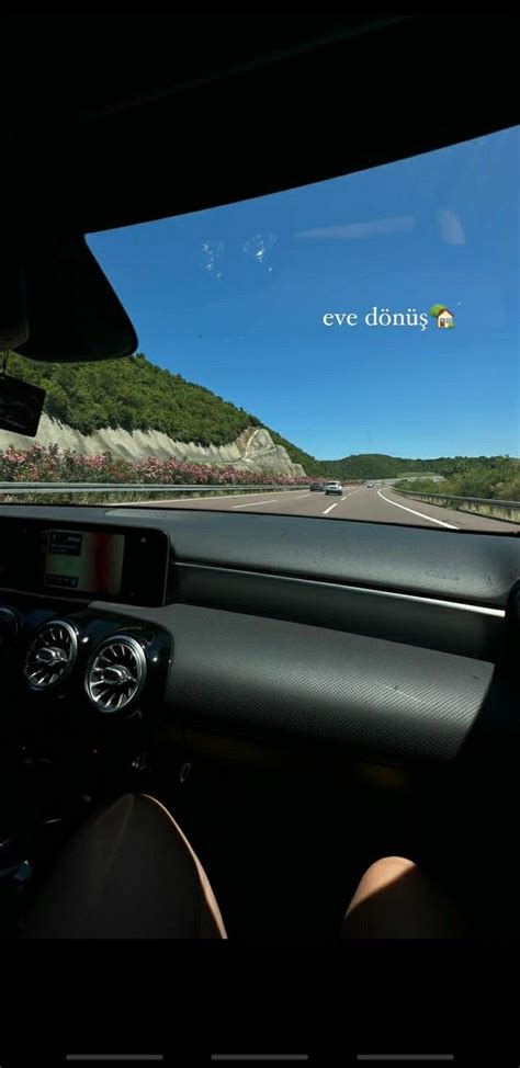 The Dashboard Of A Car Driving Down A Road