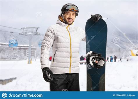 Smiling Young Man with a Snowboard Posing at a Ski Resort with a Cable Car Stock Image - Image ...