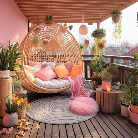 A Balcony With Lots Of Potted Plants And Hanging Chairs On The Deck