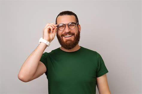 Premium Photo Young Smart Bearded Man Is Holding A Wearing A Pair Of