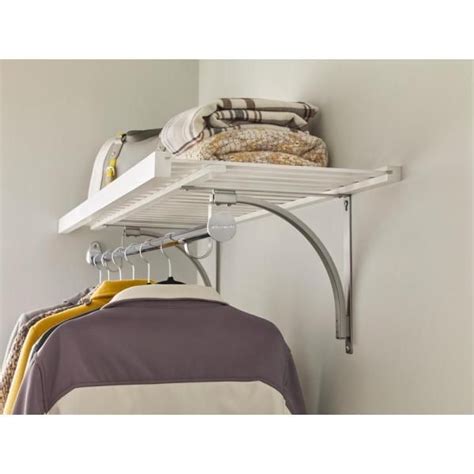 A White Shelf With Clothes Hanging From Its Sides And A Yellow Blanket