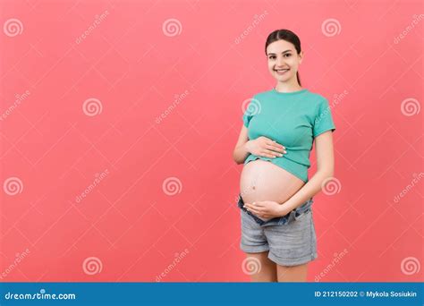 Expecting Mother In Unzipped Jeans Showing Her Naked Pregnant Belly At