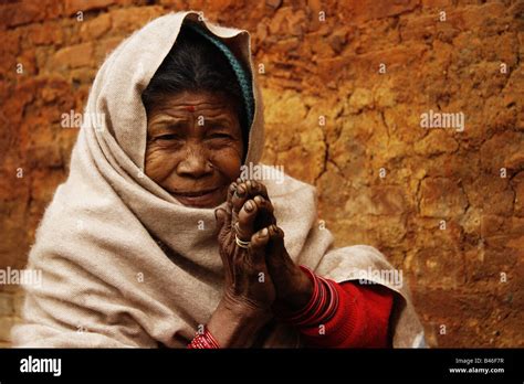 Portrait of old Nepali lady doing the Namasté hand gesture