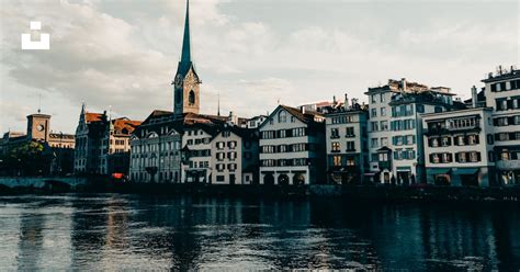 Brown And White Concrete Building Beside Body Of Water During Daytime Photo Free Zürich Image