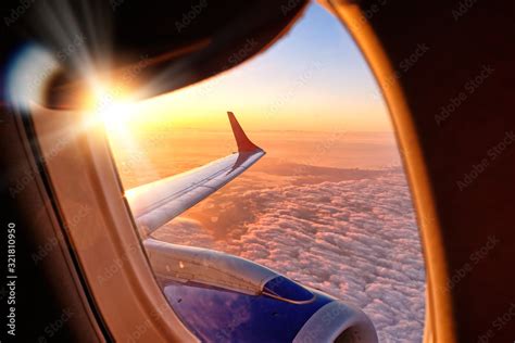 Plane Wing From Airplane Window Seat In Flight Nature Landscape Against