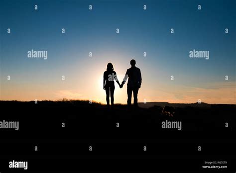 Romantic couple hug at sunset on background Stock Photo - Alamy