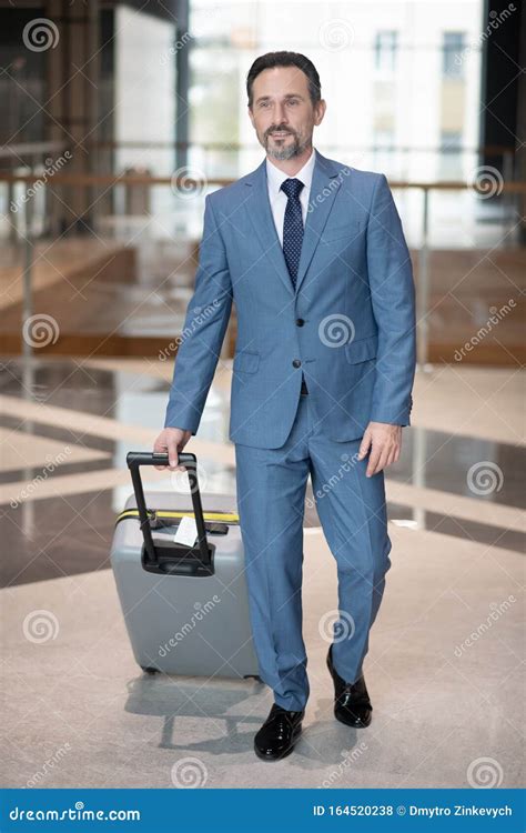 Serious Successful Businessman Walking With Luggage In The Hotel Stock