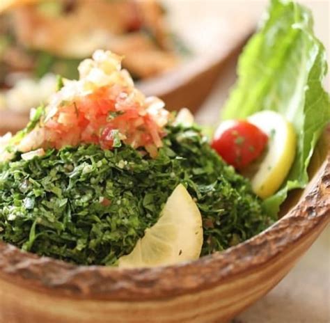 A Wooden Bowl Filled With Lots Of Green Food