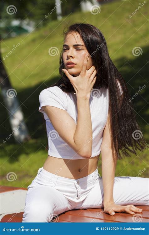 Beautiful Brunette Woman Posing Against Summer Park Bright Sunny