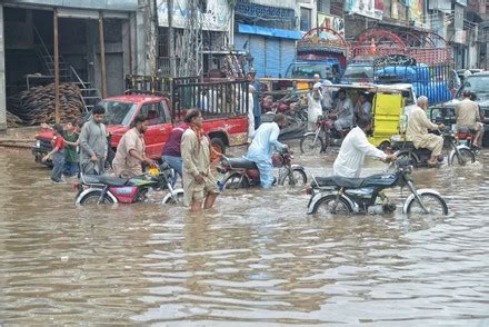 Pakistani People Wade Through Flooded Road Editorial Stock Photo