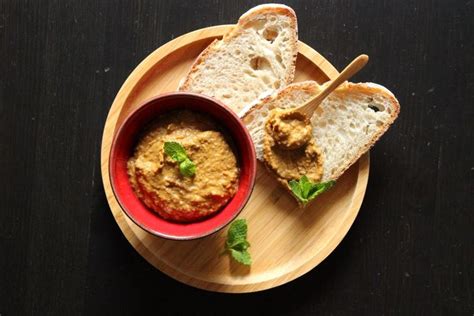 Two Pieces Of Bread On A Plate With A Bowl Of Hummus