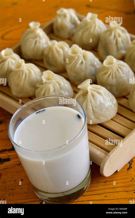 Glass of tea with yak milk and momos - Tibet China Stock Photo - Alamy