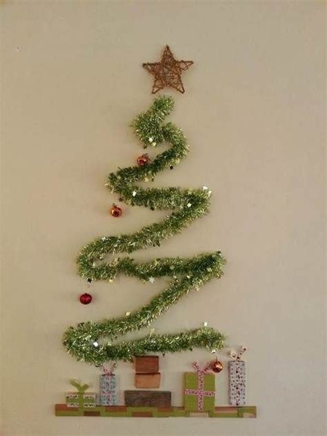 A Small Christmas Tree Is Hanging On The Wall