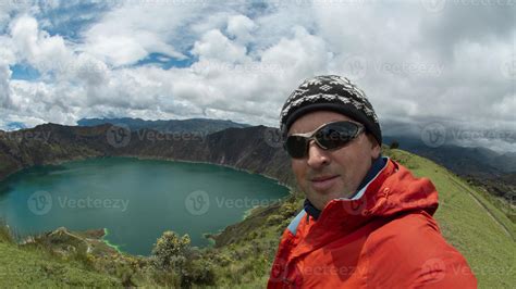 Young Tourist Man In Red Coat And Glasses Taking A Selfie Near The