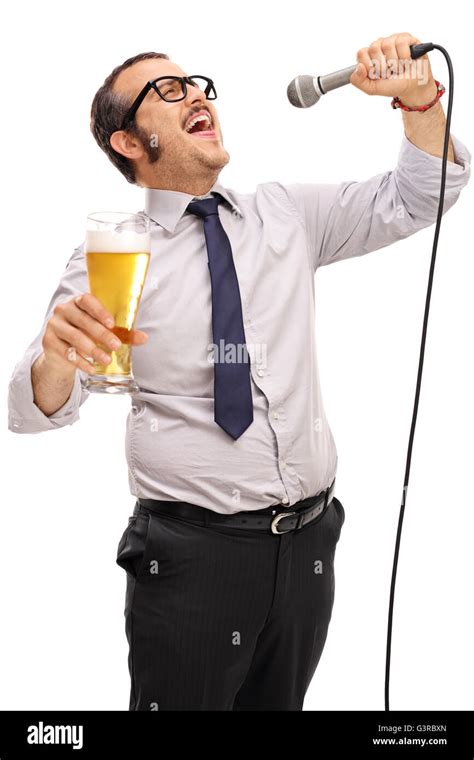 Dedicated Man Singing On A Microphone And Holding A Pint Of Beer