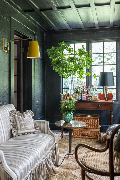 a living room filled with furniture next to a window and a plant on top of a table