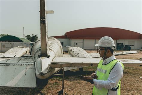 Aircraft mechanic examining airplane wing 21967981 Stock Photo at Vecteezy