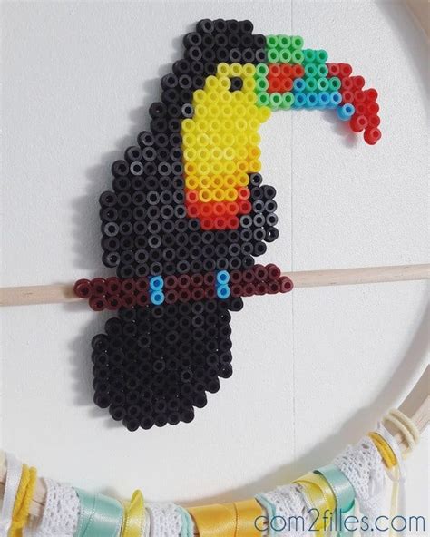 A Colorful Toucan Bird Made Out Of Legos Is Hanging On The Wall