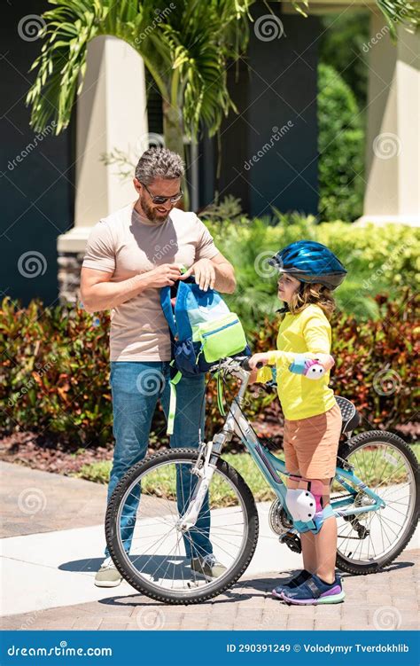 Father Helping Son Get Ready For School Father And Son On The Bicycle Father And Son Riding A