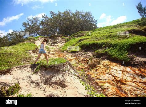 Blonde Woman Climbing A Steep Path Up To The Indian Head Outcrop A Coastal Headland On The