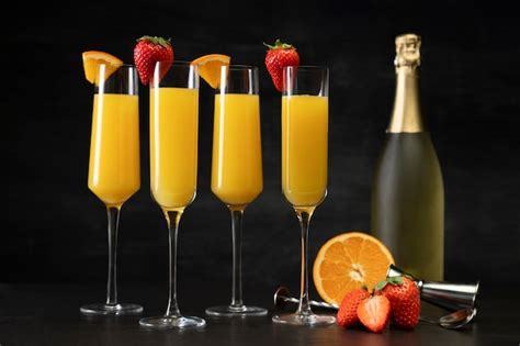 Free Photo | Mimosa cocktail glasses and bottle arrangement