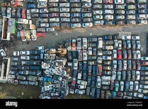 Aerial View Of Big Parking Lot Of Junkyard With Rows Of Discarded