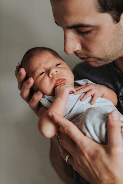 Premium Photo Young Father Holding His Baby