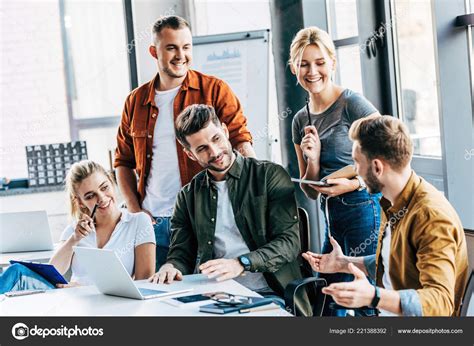 Group Young Entrepreneurs Working Laptops Chatting Together Office