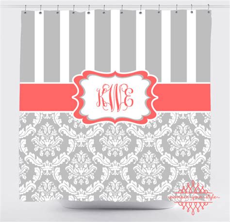 A Gray And White Shower Curtain With A Red Monogrammed Name